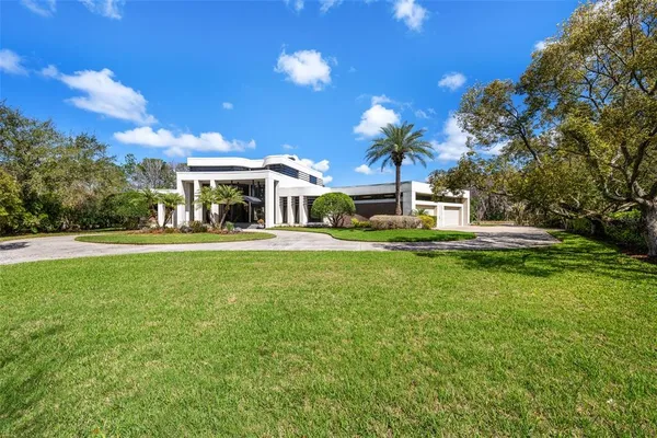 a front view of a house with a garden and yard