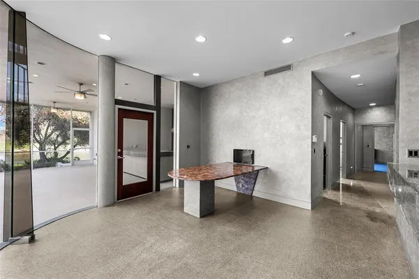 a bathroom with a granite countertop sink a toilet a mirror and bathtub