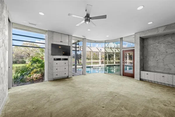 a bathroom with a granite countertop sink a toilet a mirror and bathtub
