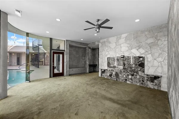a view of a living room with a ceiling fan