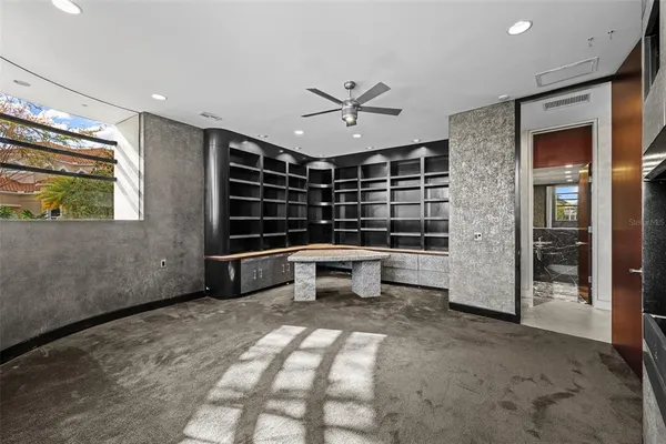 a view of an empty room with a floor to ceiling window and an outdoor view