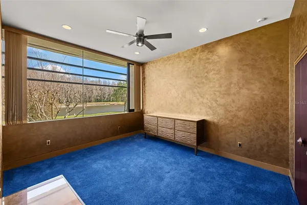 an aerial view of a house with a garden and lake view