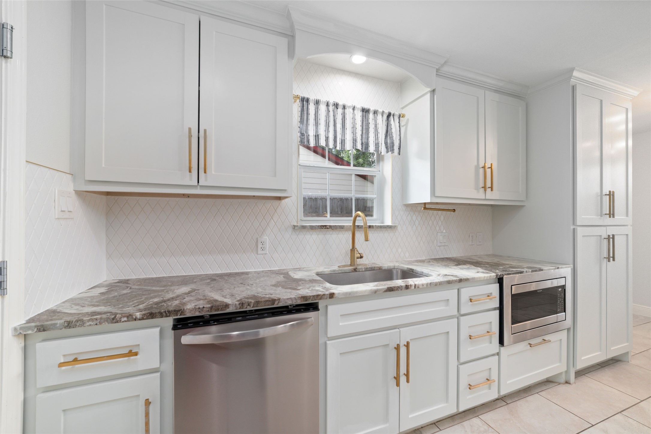 5922 Hummingbird Street Houston, TX 77096 - Photo 10 of 26 Cabinetry extends to the ceiling, offering exceptional storage and a timeless custom look. Every detail was selected to create a kitchen you'll love for years to come.