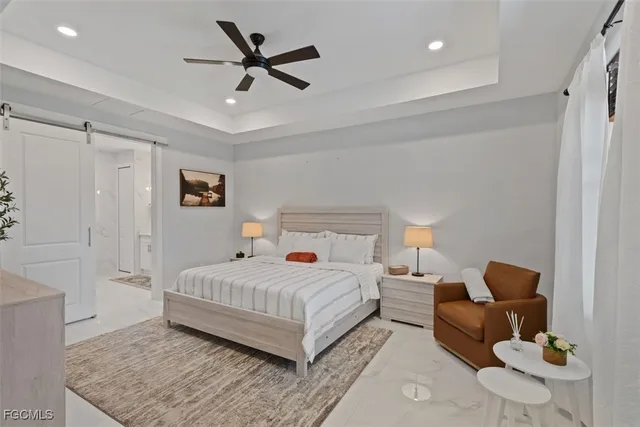 a bedroom with a bed couch and a window