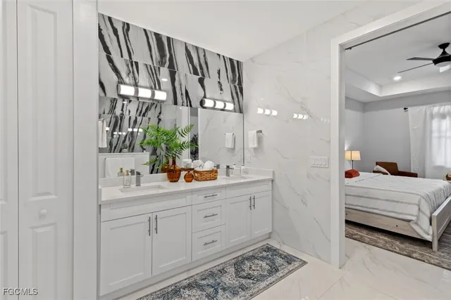 a en suite bathroom with a double vanity sink and a mirror