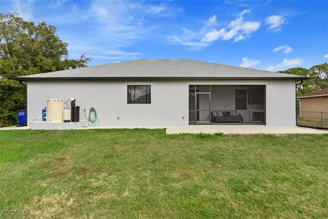 a view of a backyard with a barbeque grill and plants