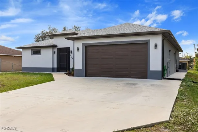 a view of garage with a yard