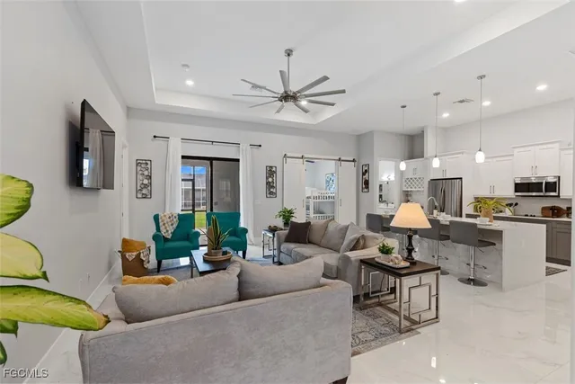 a living room with furniture and a chandelier