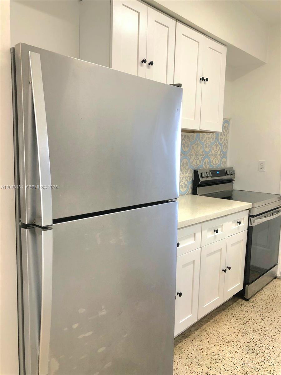 7135 Rue Granville, Unit 4 Miami Beach, FL 33141 - Photo 3 of 9 a white refrigerator freezer sitting in a kitchen