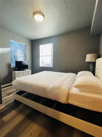 a bedroom with a bed and a window