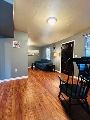a workspace with furniture wooden floor and window