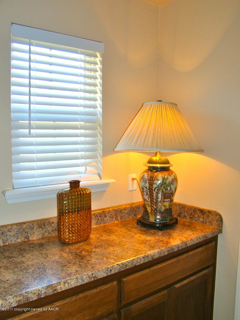 3715 Arden Road Amarillo, TX 79118 - Photo 11 of 24 a view of a sink with a dining table and chair