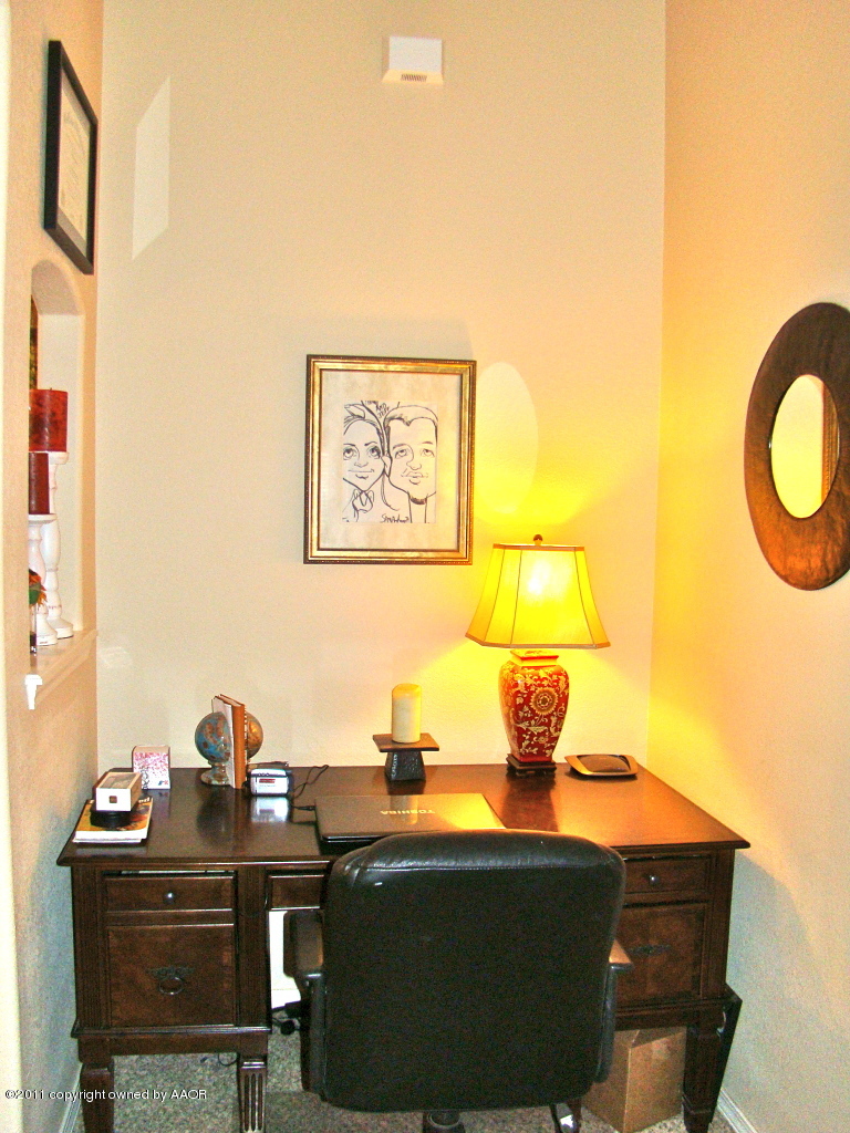 3715 Arden Road Amarillo, TX 79118 - Photo 13 of 24 a lamp on top of a table and paintings on the wall