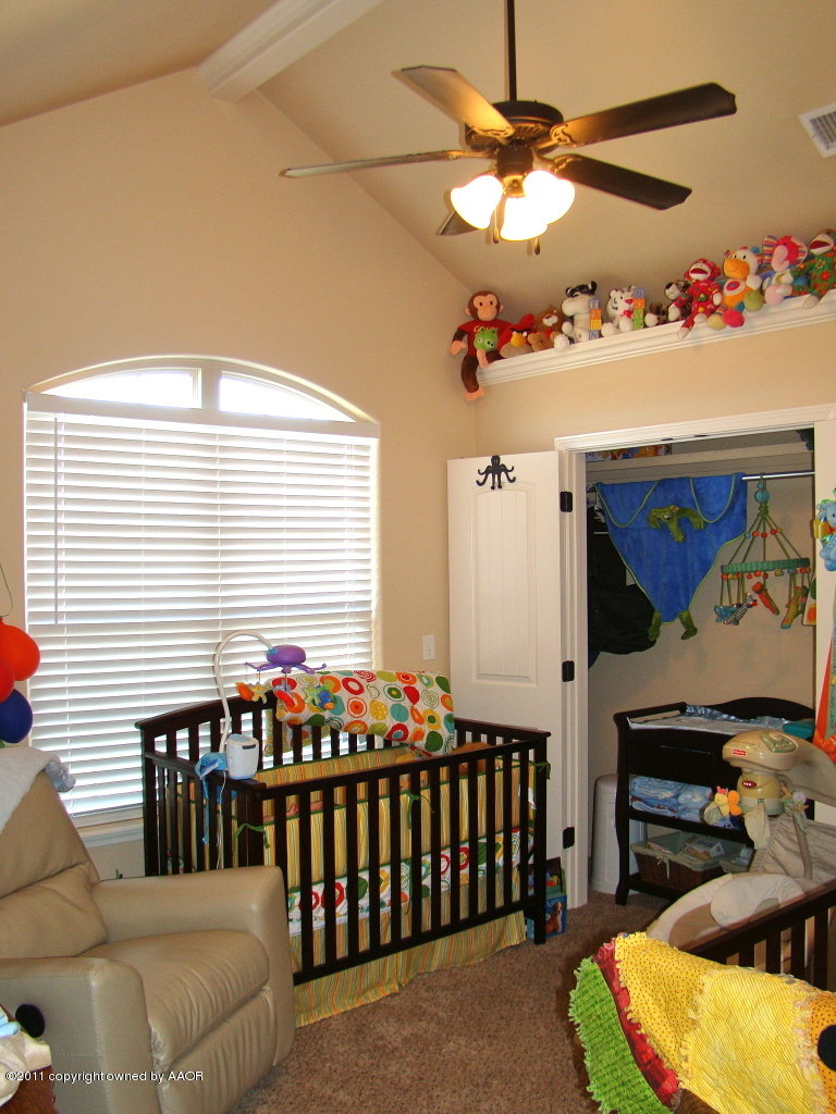 3715 Arden Road Amarillo, TX 79118 - Photo 19 of 24 a bedroom with furniture and a window