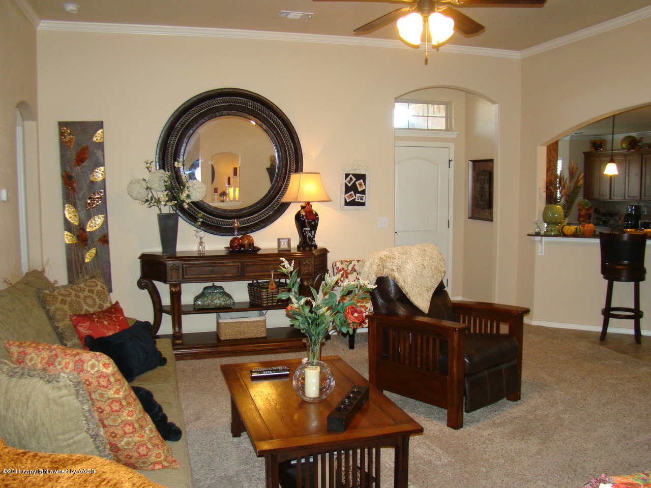 3715 Arden Road Amarillo, TX 79118 - Photo 3 of 24 a living room with furniture a mirror and a chandelier