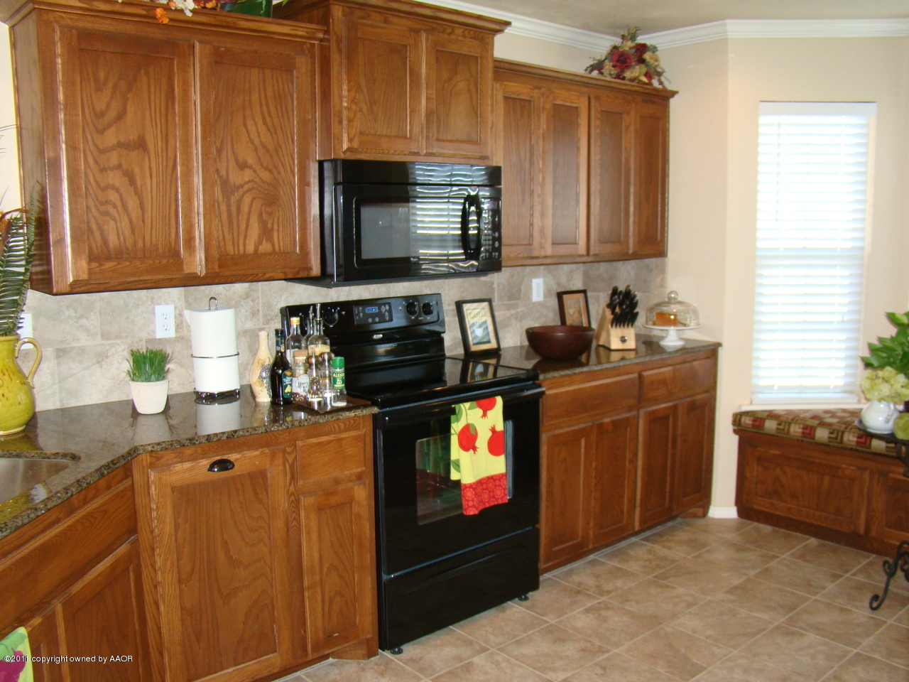 3715 Arden Road Amarillo, TX 79118 - Photo 7 of 24 a kitchen with stainless steel appliances granite countertop a stove a sink and a microwave