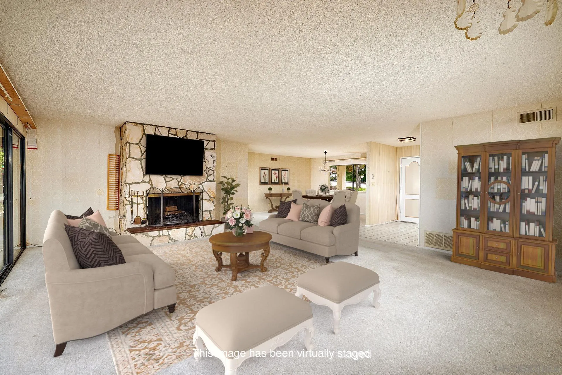 7774 Via Capri La Jolla, CA 92037 - Photo 12 of 45 a living room with furniture a flat screen tv and a fireplace