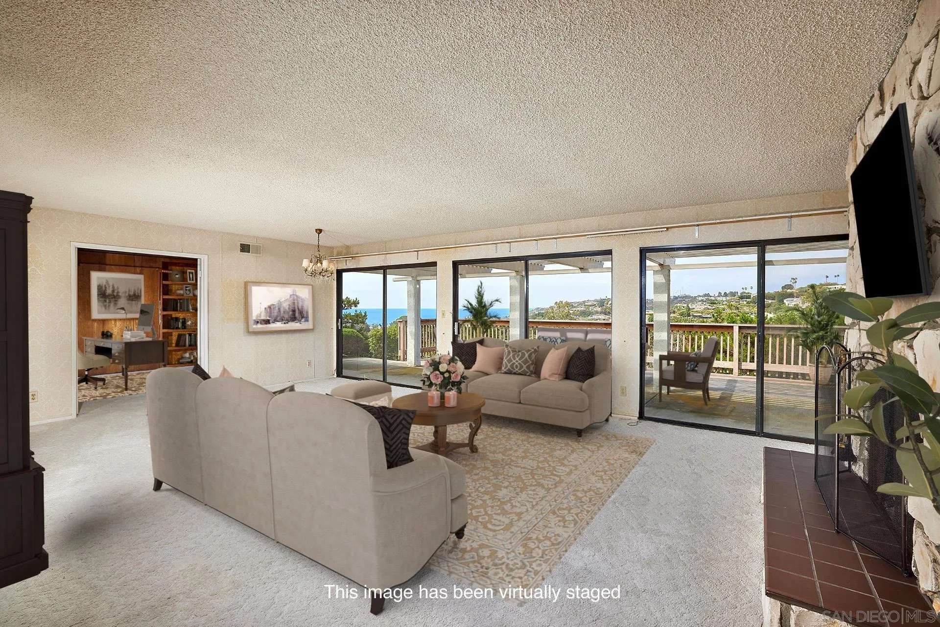 7774 Via Capri La Jolla, CA 92037 - Photo 16 of 45 a living room with furniture large window and a flat screen tv