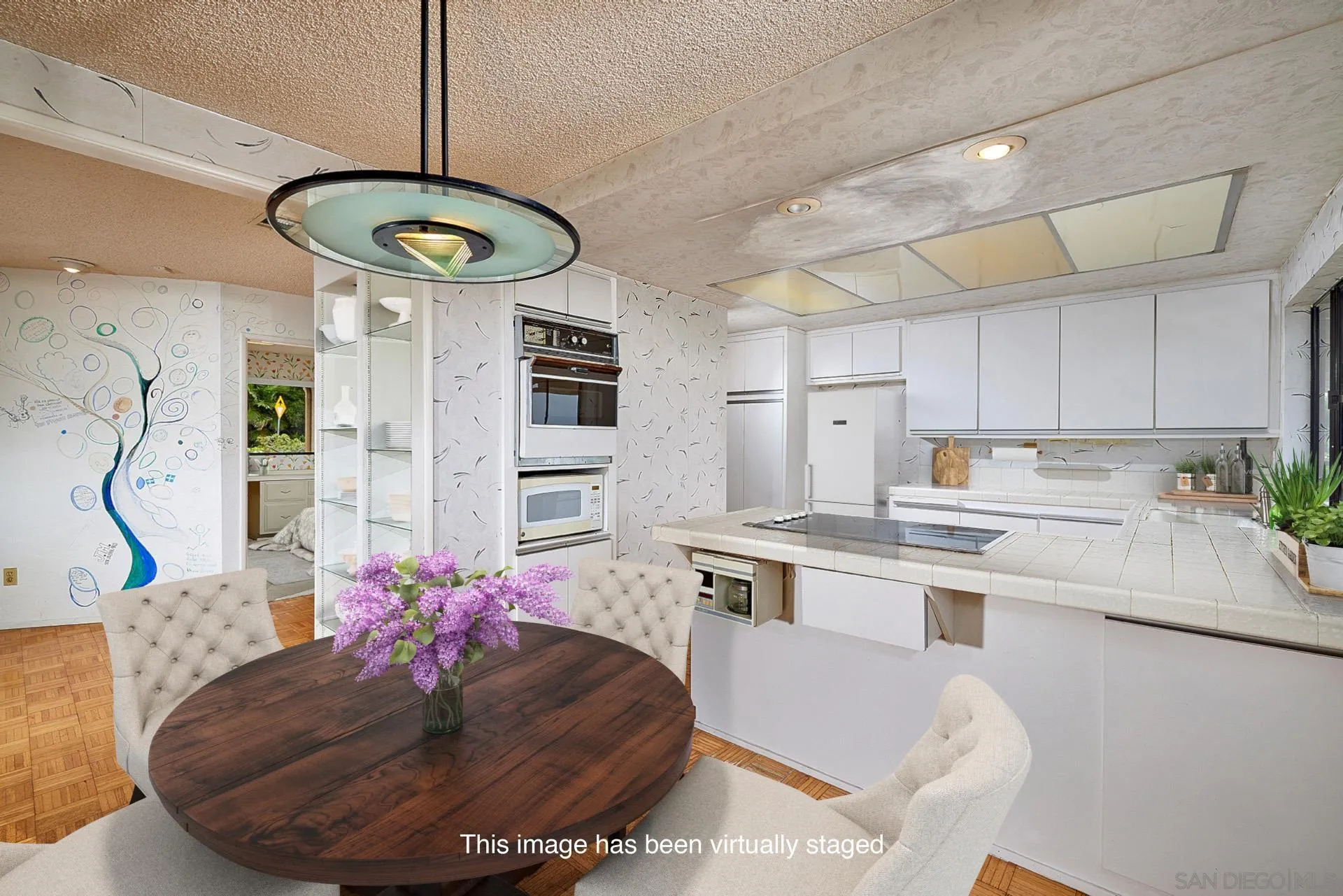 7774 Via Capri La Jolla, CA 92037 - Photo 21 of 45 a kitchen with stainless steel appliances granite countertop a sink refrigerator dining table and chairs