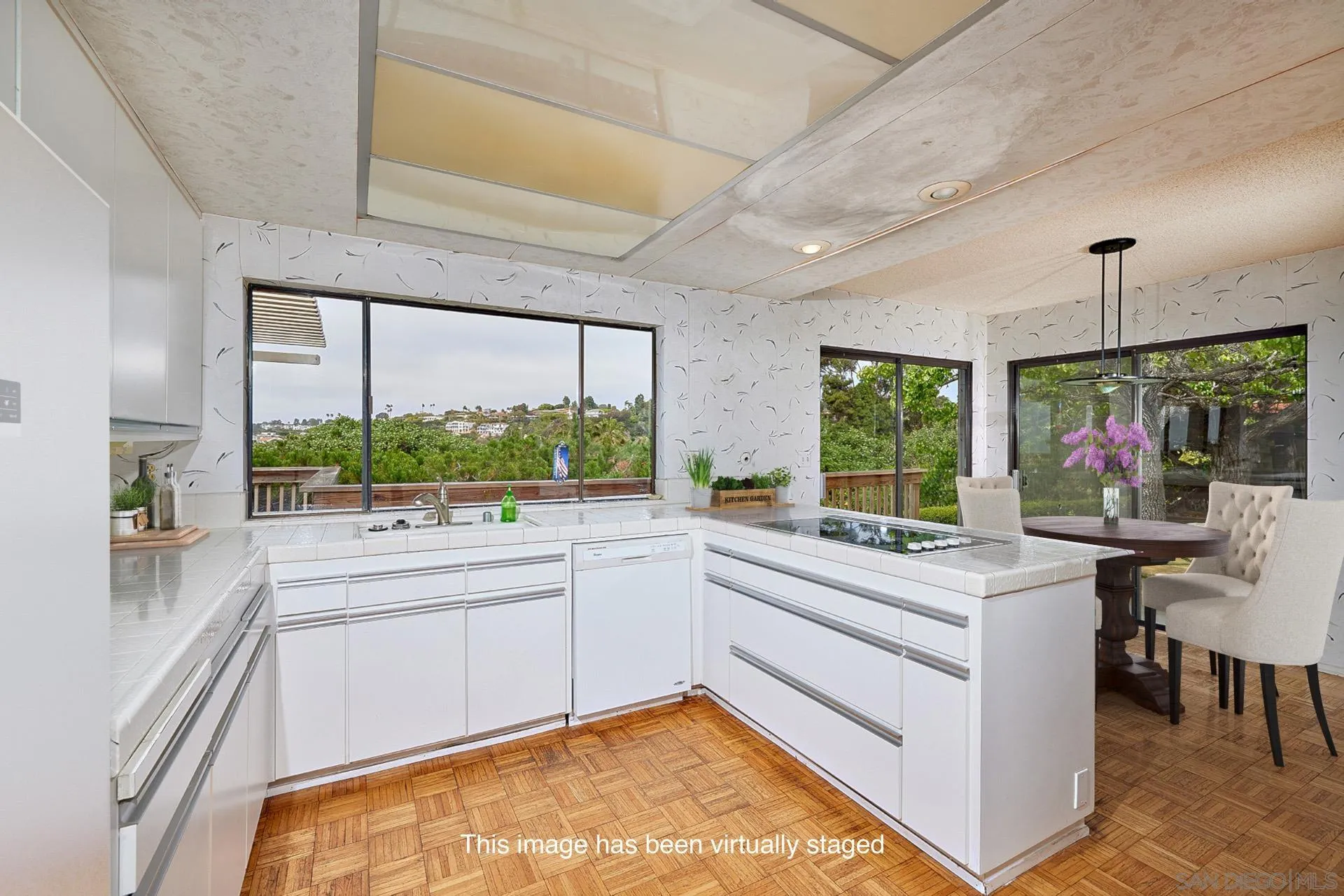 7774 Via Capri La Jolla, CA 92037 - Photo 22 of 45 a large white kitchen with a large window
