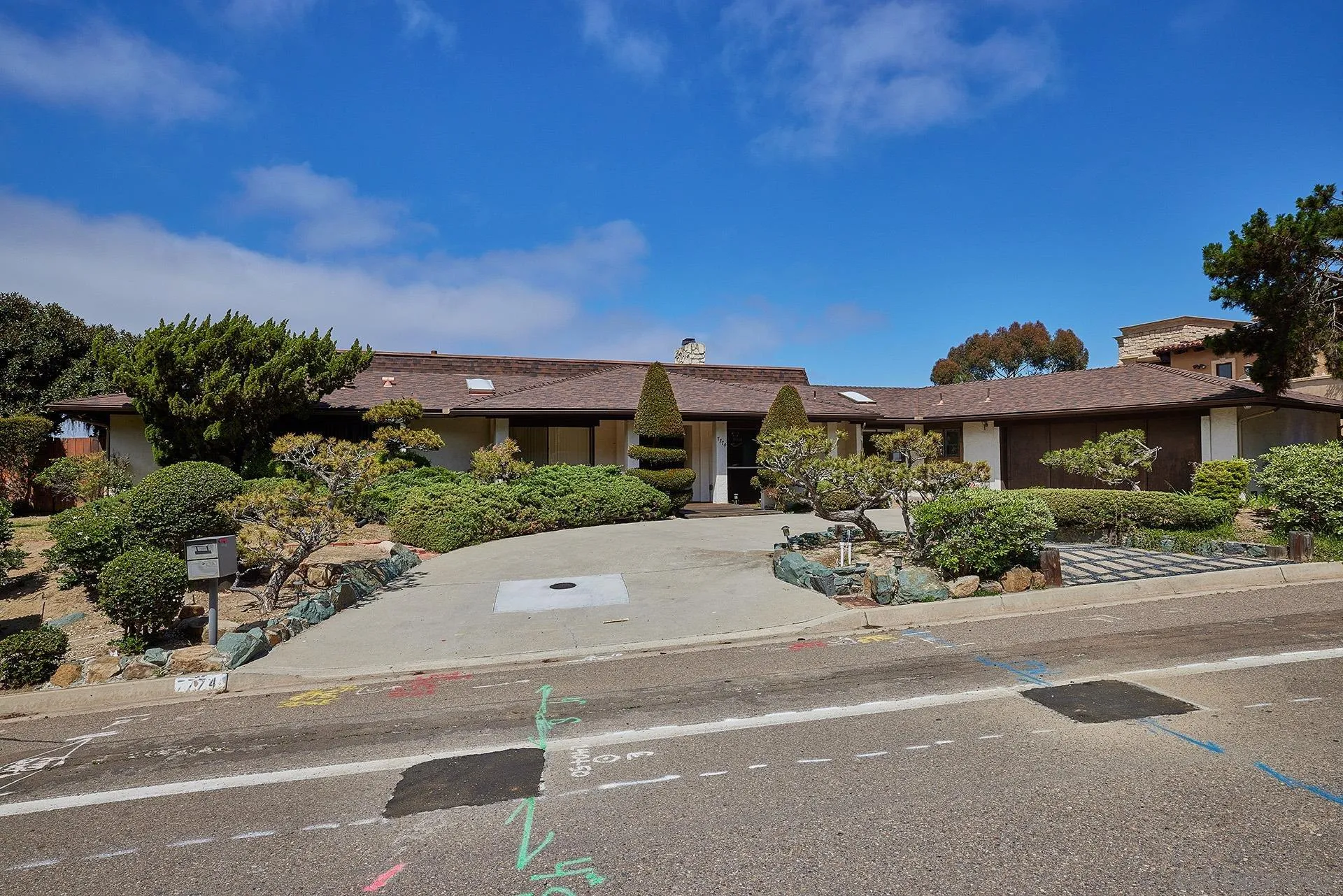 7774 Via Capri La Jolla, CA 92037 - Photo 26 of 45 front view of a house with a yard