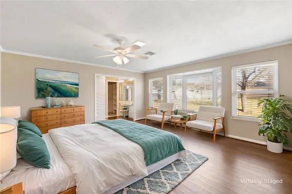a spacious bedroom with a balcony a bed and a couch
