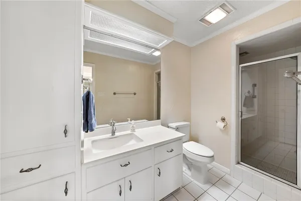 a bathroom with a sink a toilet a shower and a mirror