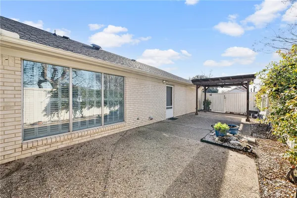 a backyard of a house with table and chairs