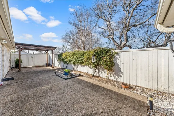 a view of a street with a large tree