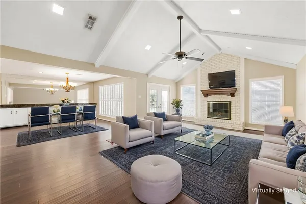 a living room with furniture a fireplace and a flat screen tv