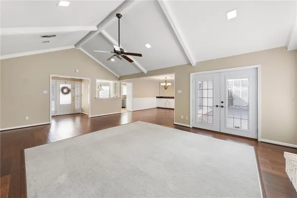 a view of an empty room with window and cabinet