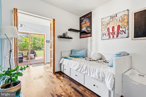 a bedroom with furniture and a large window