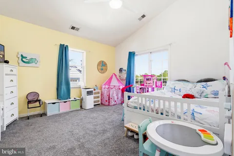 a bedroom with baby toys and dresser