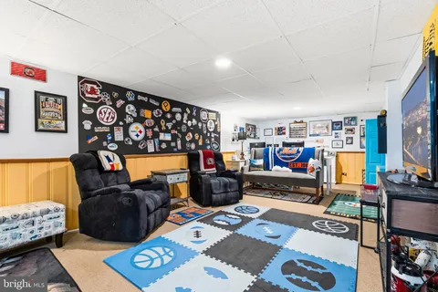 a bed room with furniture and a flat screen tv