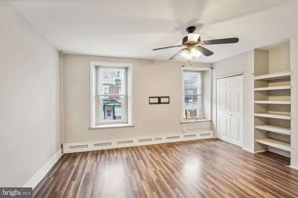 wooden floor in an empty room with a window