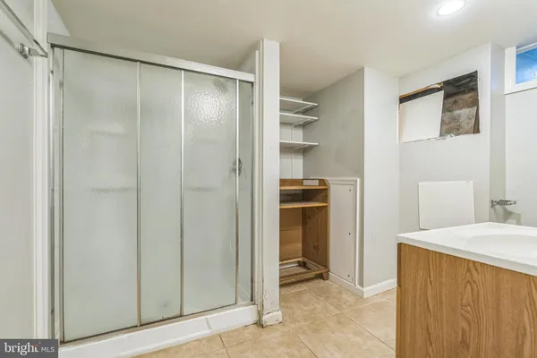 a bathroom with a shower and a sink