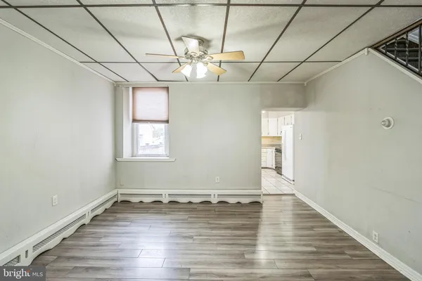 a view of a room with wooden floor and chandelier