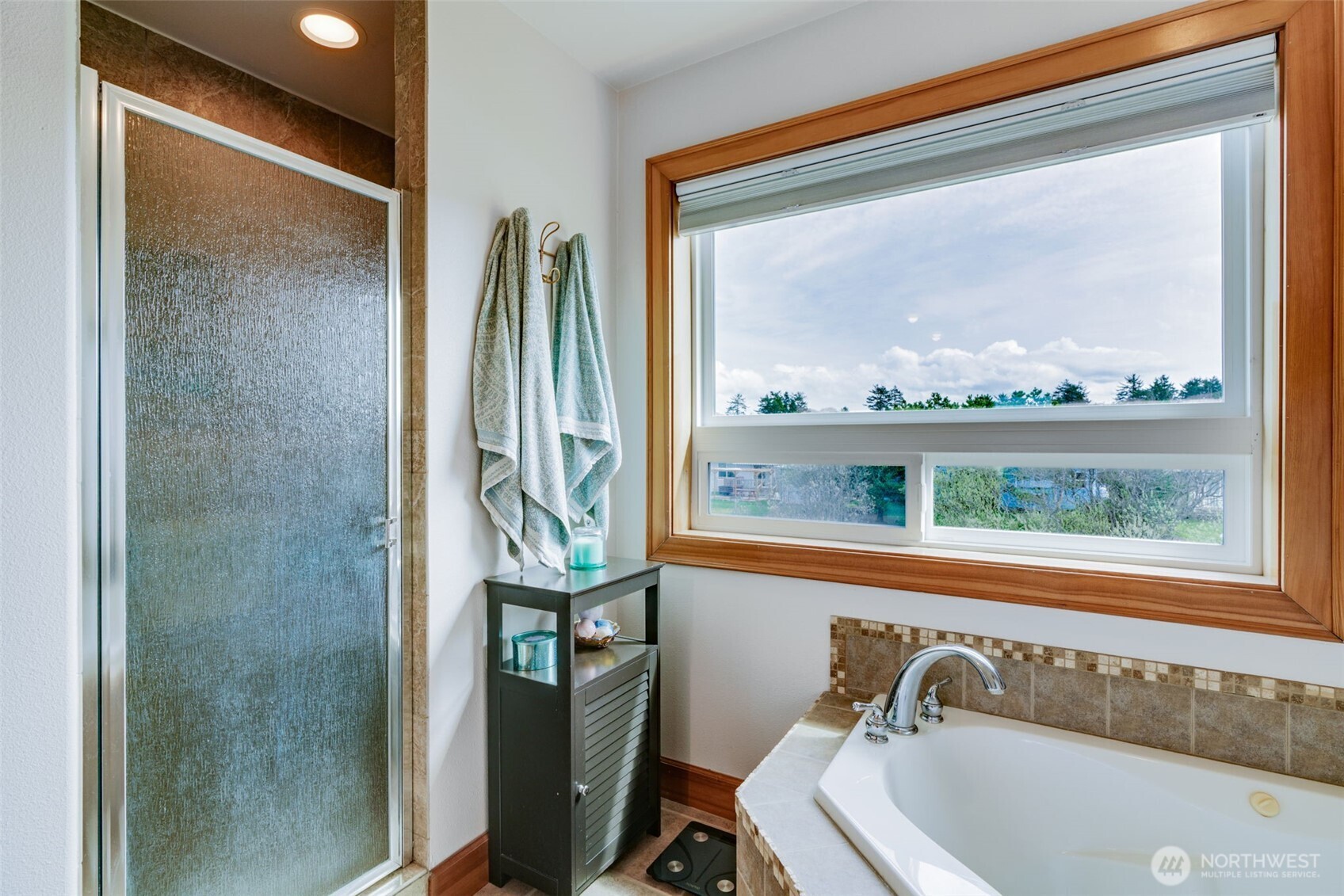33410 G Street Ocean Park, WA 98640 - Photo 17 of 40 a bathroom with a bathtub and a window