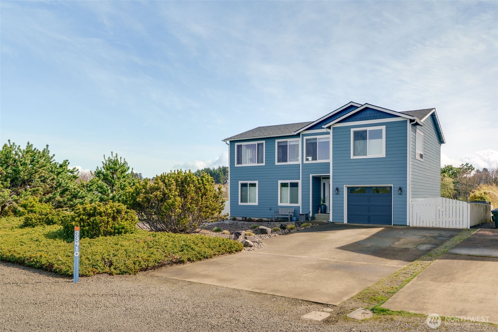 33410 G Street Ocean Park, WA 98640 - Photo 2 of 40 a front view of a house with a yard and garage