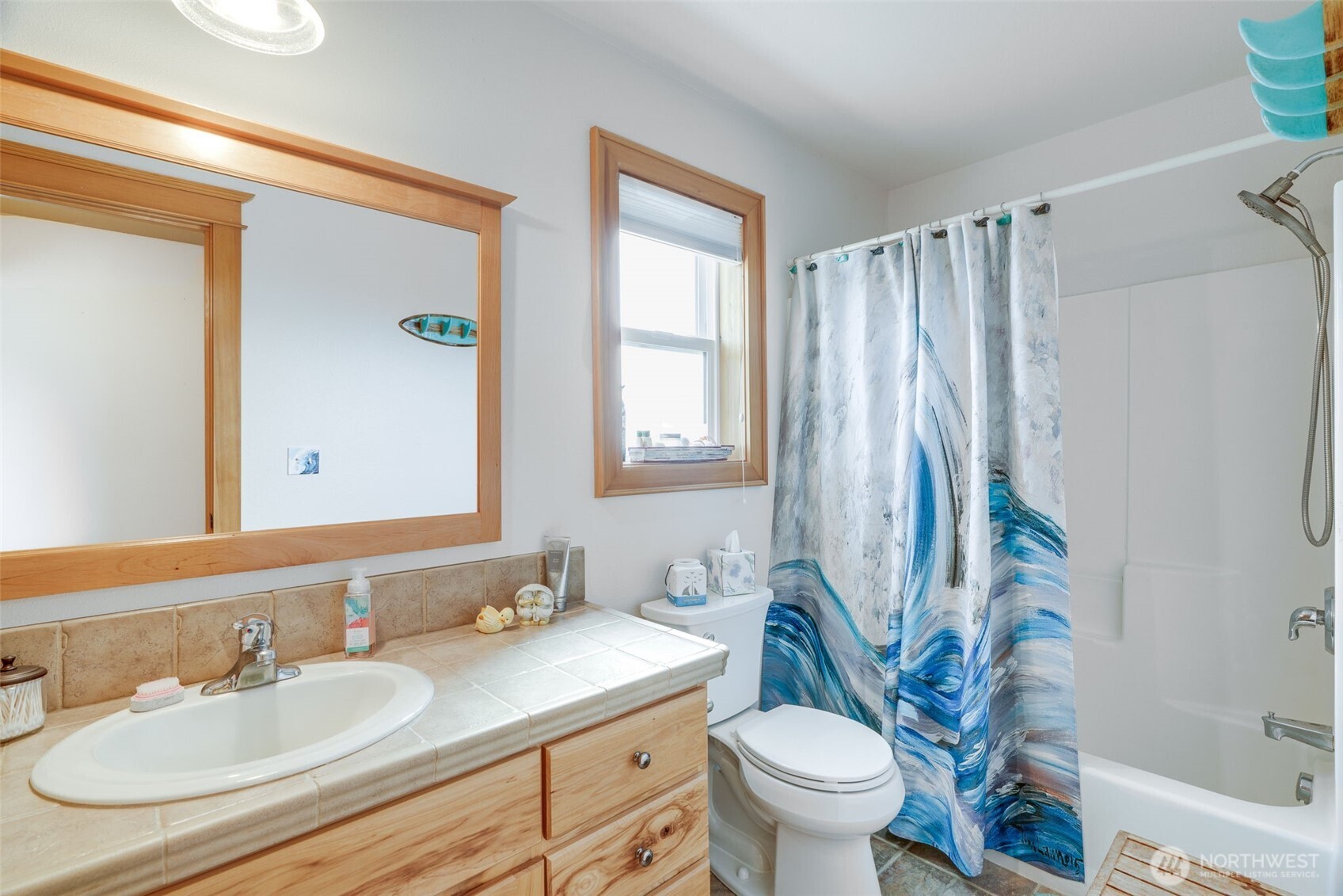 33410 G Street Ocean Park, WA 98640 - Photo 6 of 40 a bathroom with a granite countertop sink toilet and a mirror