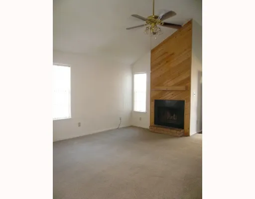 a view of empty room with a fireplace