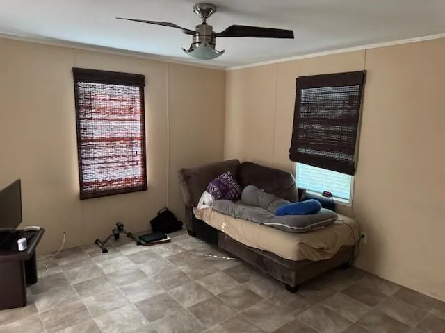 a living room with furniture a window and a flat screen tv