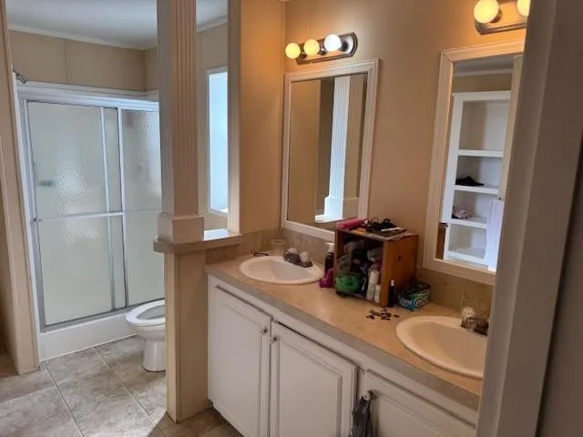 a bathroom with a sink a toilet and a mirror