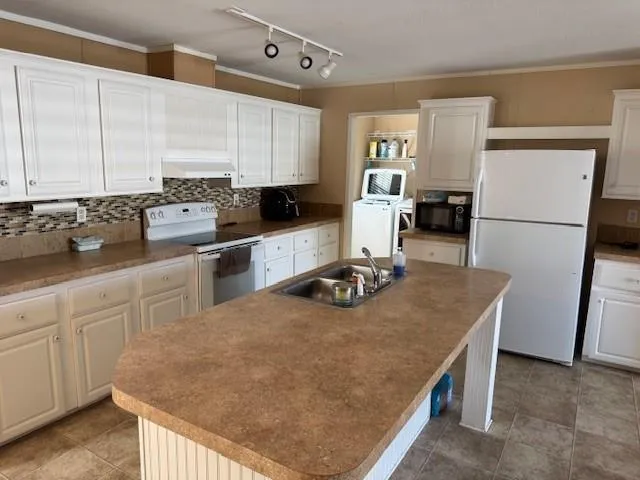 a kitchen with a sink a stove and refrigerator