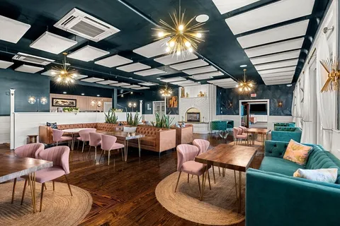 a living room with lots of furniture and a chandelier
