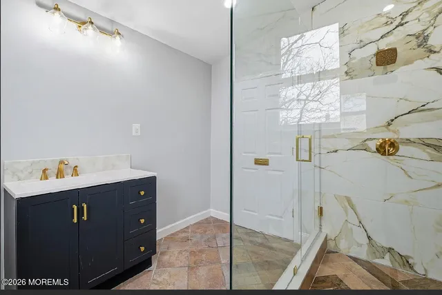 a bathroom with a sink and mirror