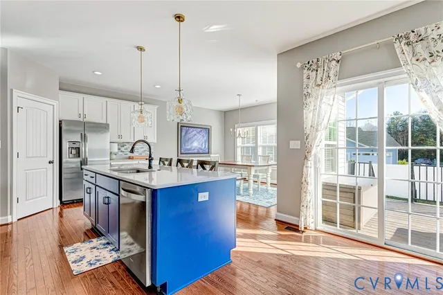 a kitchen with granite countertop a sink appliances and cabinets