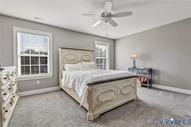 a spacious bedroom with a bed and a table in it