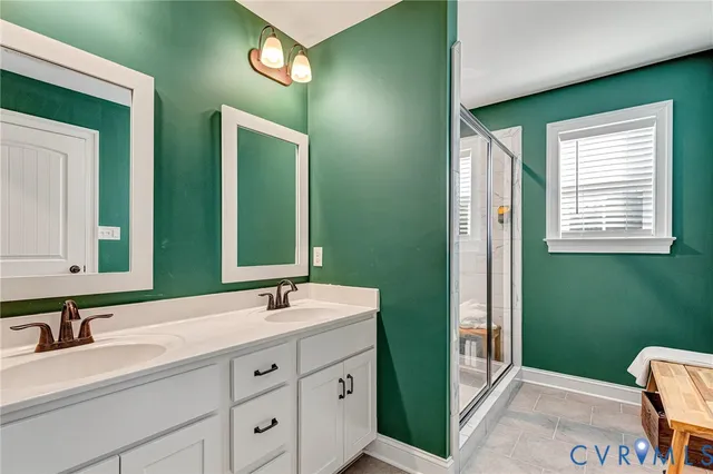 a bathroom with 2 sink tub and a mirror