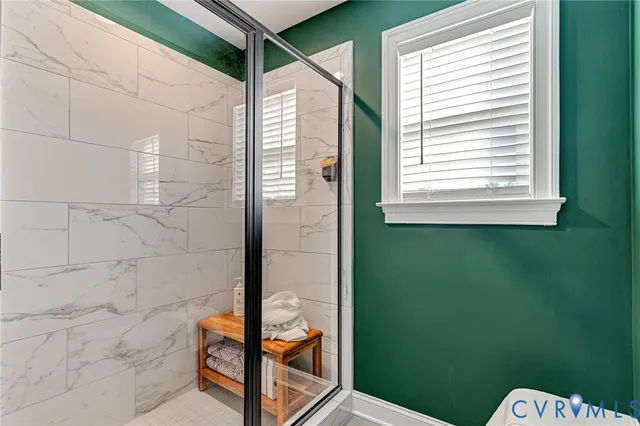 a bathroom with a window and a shower